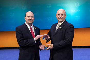 ABF Freight's Bryan Swaim, vice president – pricing, treasurer & controller, (left) and Gary Hunt, vice president – equipment & maintenance, accept the 2018 SmartWay Freight Carrier Excellence Award. 